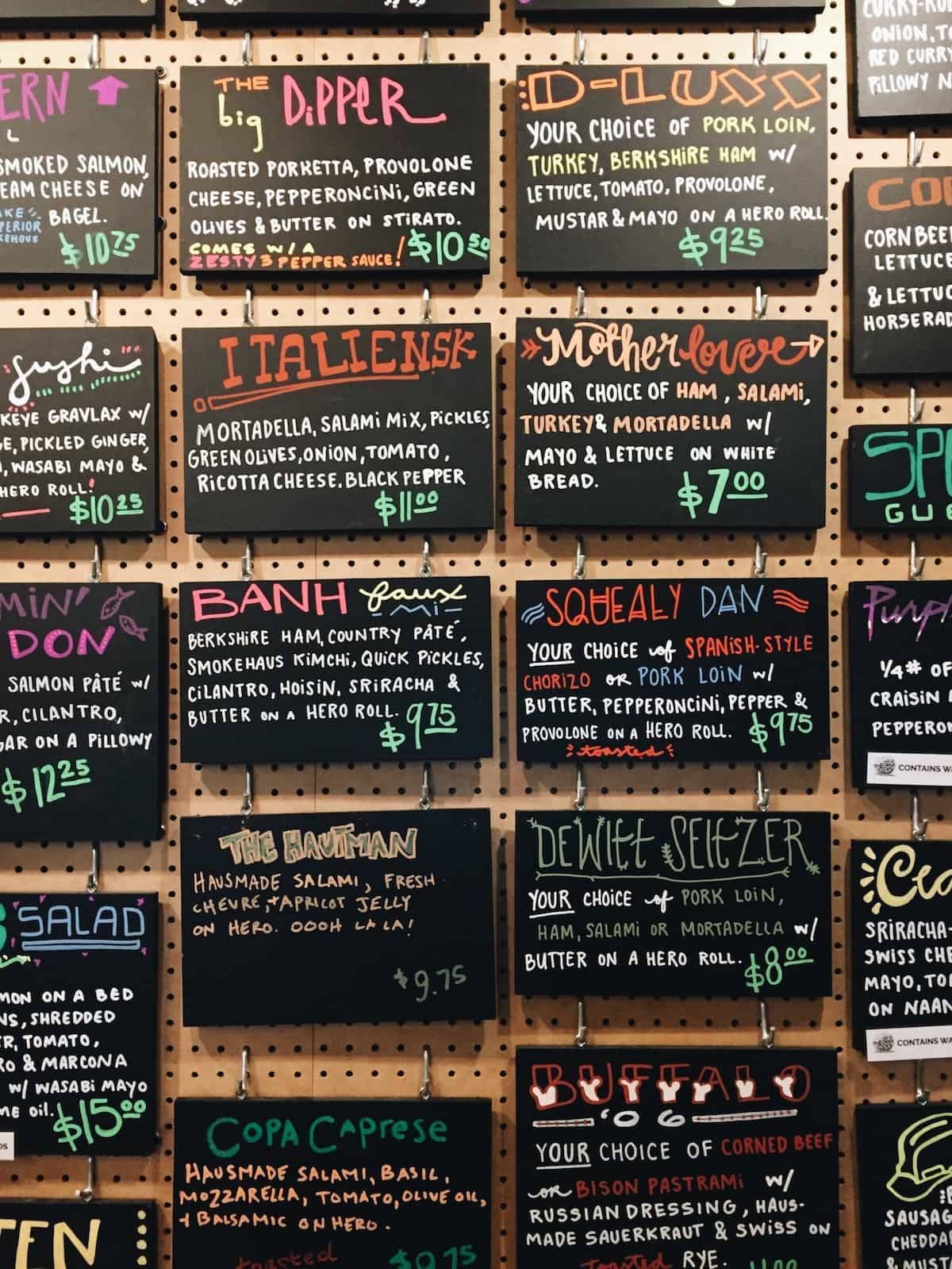 Hand written signs handing on cork board.