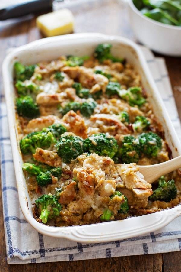Chicken Quinoa and Broccoli Casserole being dished out with a wooden spoon.