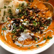 Carrot soup with ground beef topping.