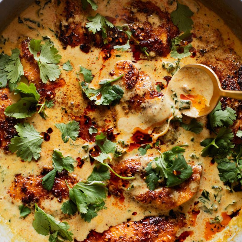 Chicken in a coconut sauce in a pan.