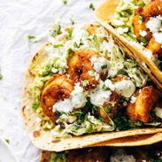 Shrimp tacos with sauce.