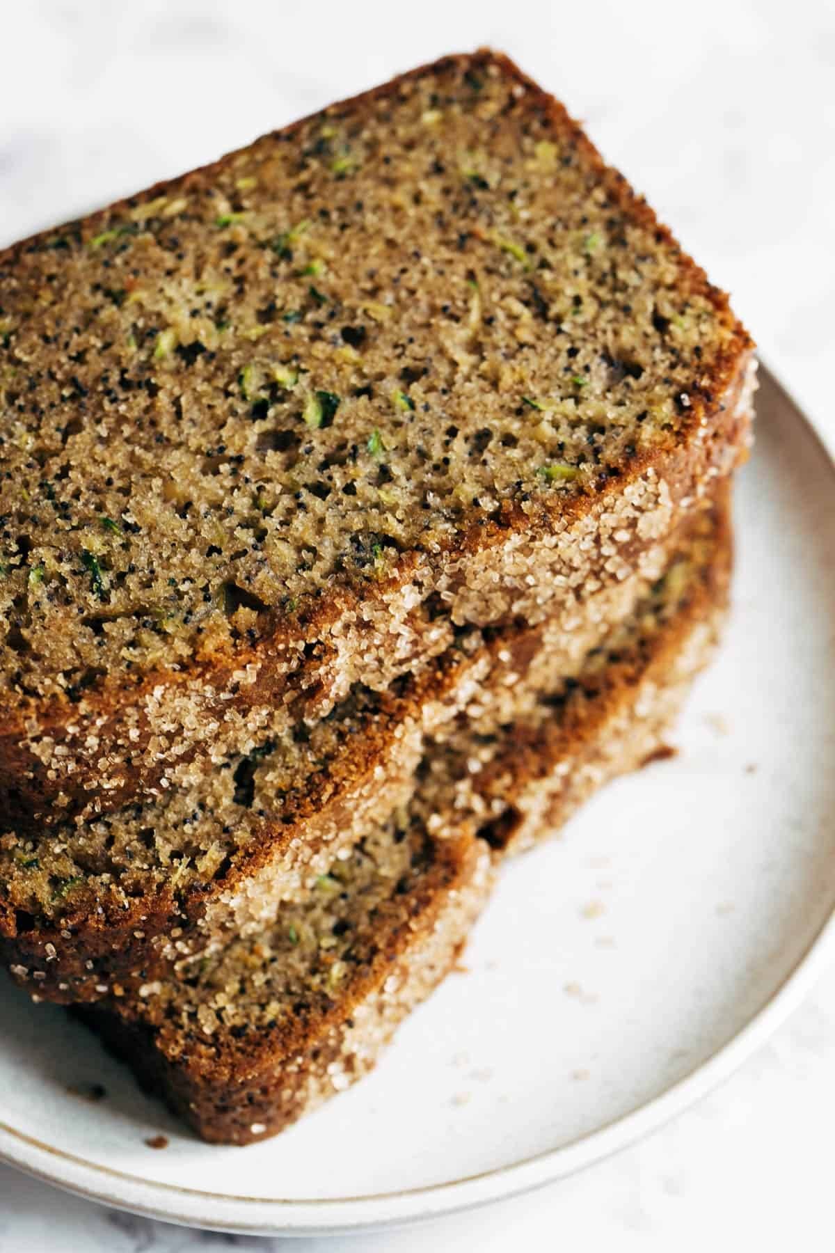 Lemon Poppyseed Zucchini Bread sliced on a plate.