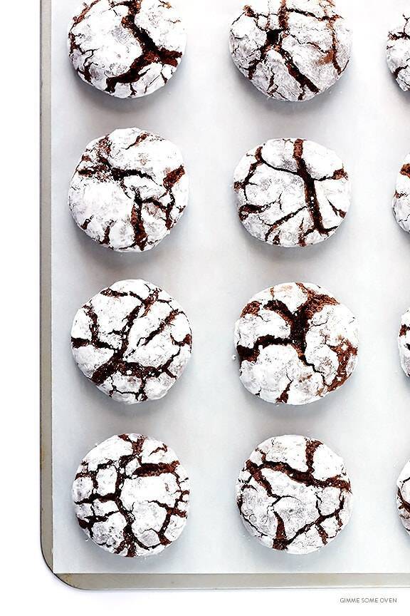 Chocolate crinkle cookies on a sheet pan.