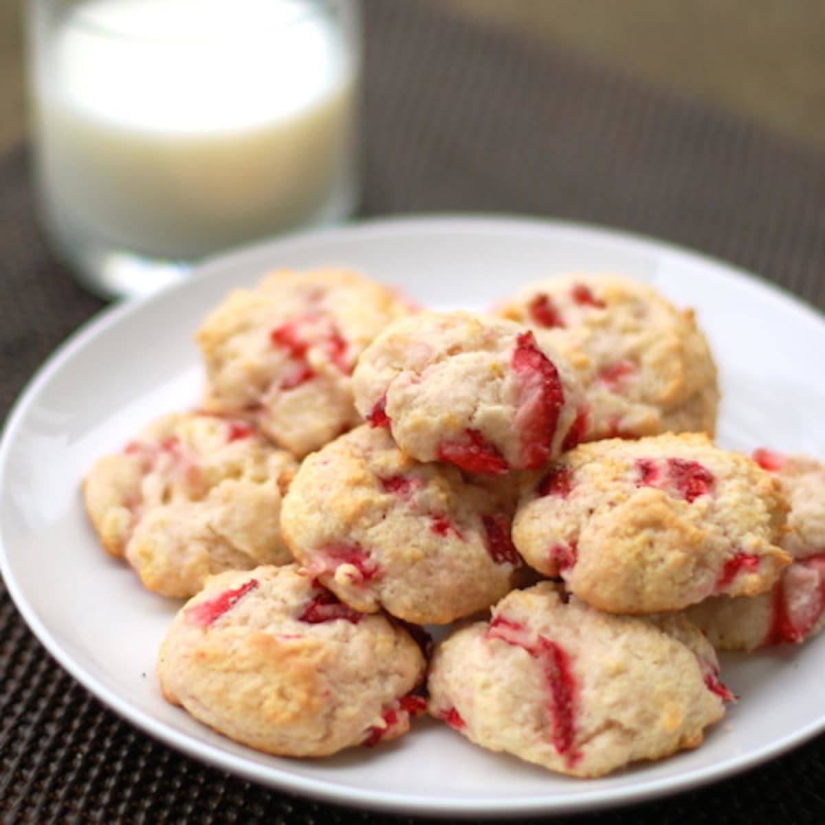 A pile of orangeberry shortcake cookies on a white plate.