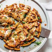 Sweet Potato Pizza on pizza pan with spatula.