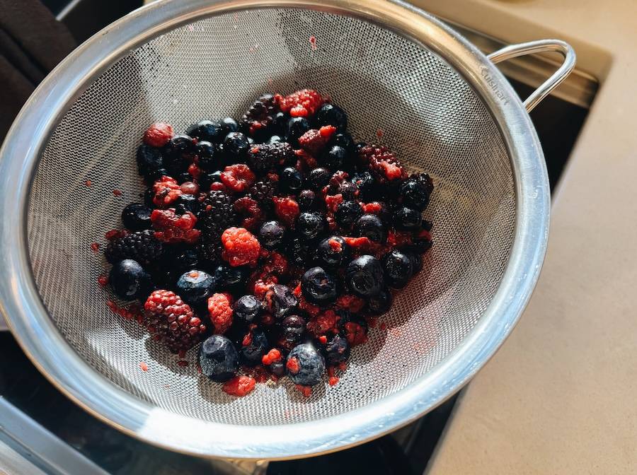Rinsed berries in a strainer.